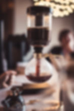 A siphon coffee maker in the middle of brewing coffee at a Foxtail Coffee location.